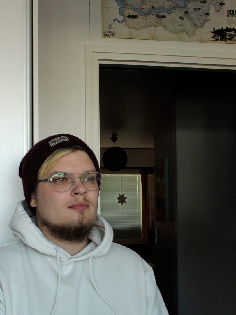 Self portrait of Joonatan Kytönen, sitting and watching forward in a slight angle.